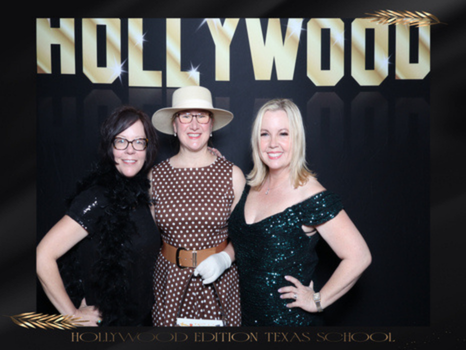 A group of guests in front of a Hollywood sign backdrop, photographed at a Curator booth.