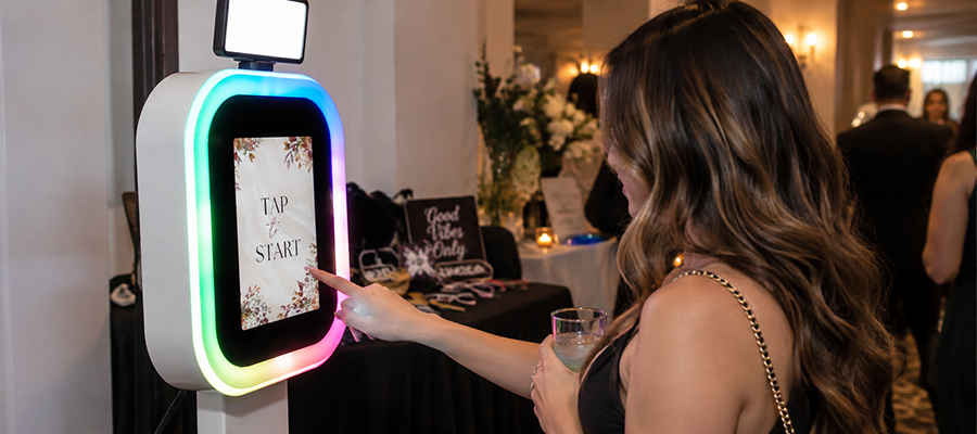 A Curator iPad booth on a lit stand at a formal event, ready for the next guest.
