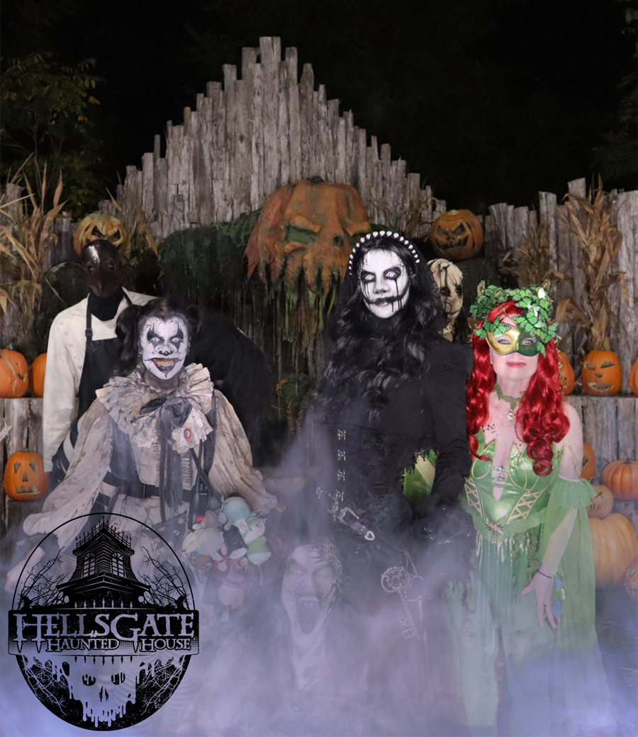 Scare actors in the fog at a haunted attraction, photographed for the guests queueing behind them.